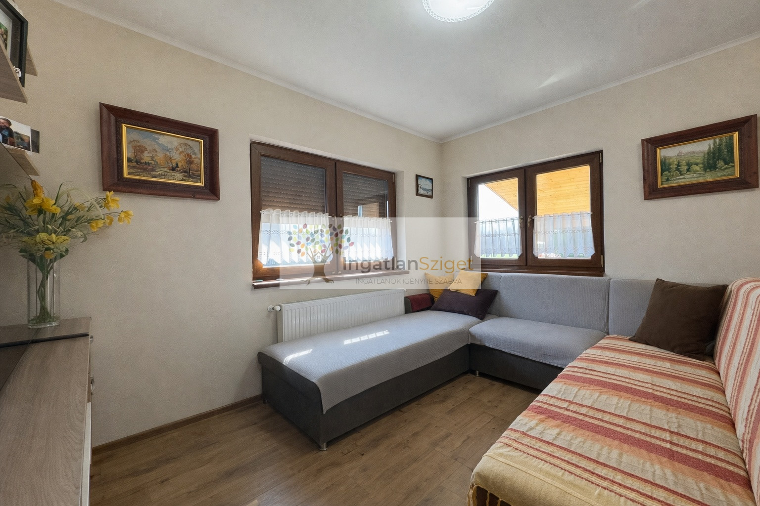 a_digital_photograph_shows_a_tidy_living_room_duri